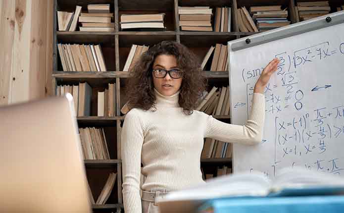 A teacher on the whiteboard. A female teacher on the white board teaching her online Master of Computer Science class.