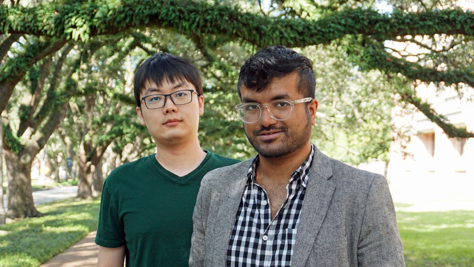 Tianyang Pan and Rahul Shome stand under a tree on campus at Rice University