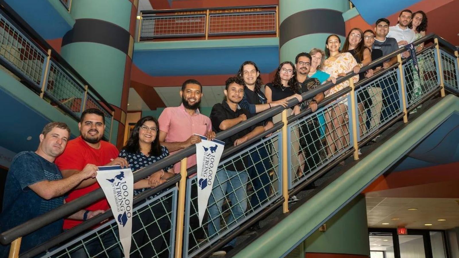 Rice faculty and Brazilian students line up along a stairwell