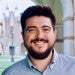 Man with beard stands outside on Rice University campus