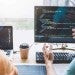 Two data science programmers coding and collaborating on ML models together at work